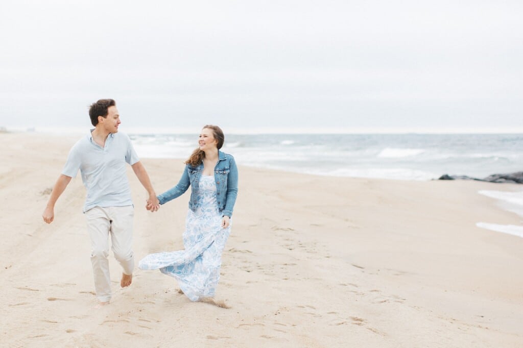 Couple walking hand-in-hand along a serene Jersey Shore beach, showcasing romance and relaxation, with gentle waves and soft sand in the background.