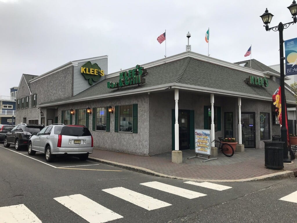Klee's Bar and Grill exterior in Seaside Heights, featuring a welcoming entrance, Irish pub vibe, and nearby parked cars, showcasing a local dining gem with a rich history.