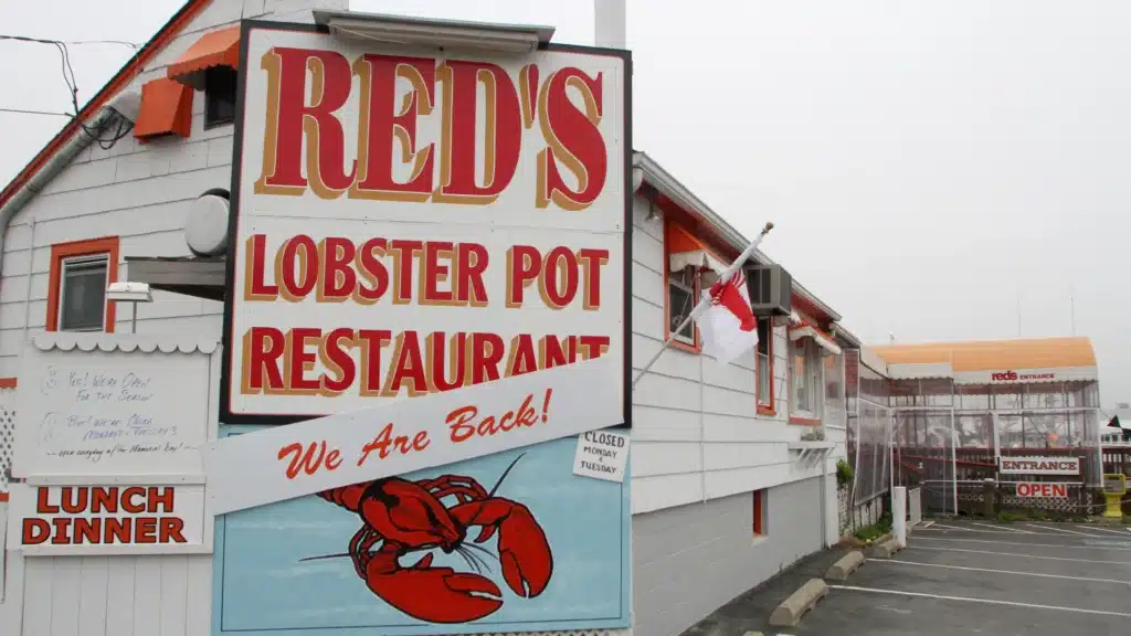 Red's Lobster Pot Restaurant sign featuring lobster graphic, showcasing the welcoming atmosphere of a popular seafood dining spot in Point Pleasant Beach, known for its locally sourced seafood and friendly service.