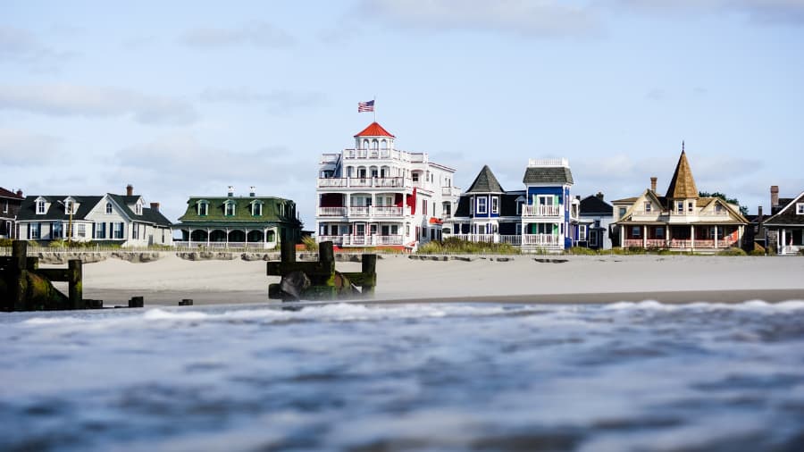 Victorian houses lining the beach in Cape May, showcasing historic architecture and a coastal retreat atmosphere.