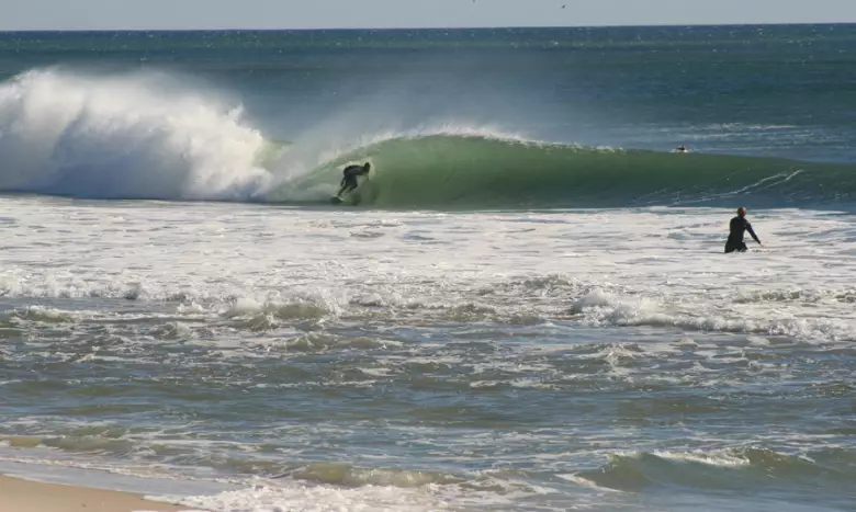 Surfer riding a wave at Seaside Park beach, showcasing ideal conditions for surfing along the Jersey Shore.