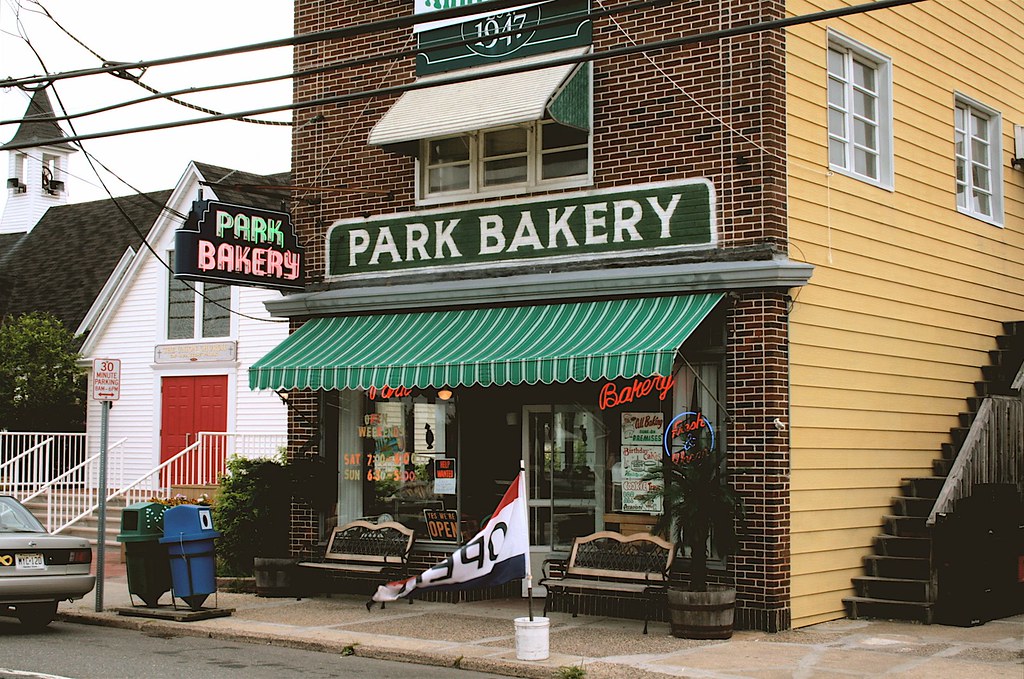 Park Bakery storefront in Seaside Park, featuring green and white awning, vintage signage, and colorful bakery displays, highlighting a local gem for pastries and community events.