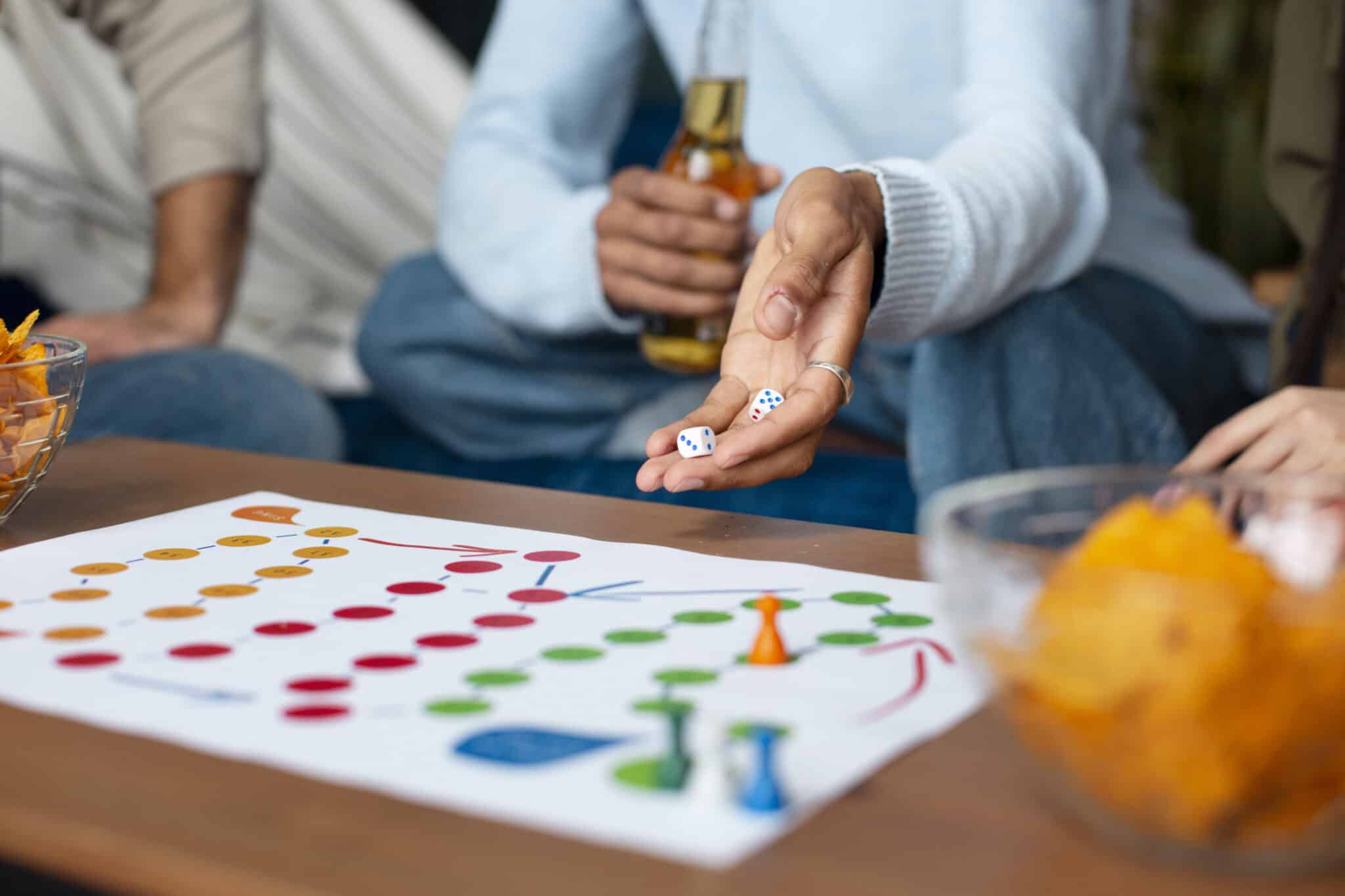 Friends enjoying a board game night, rolling dice and sharing snacks, highlighting entertainment options available in vacation rentals.