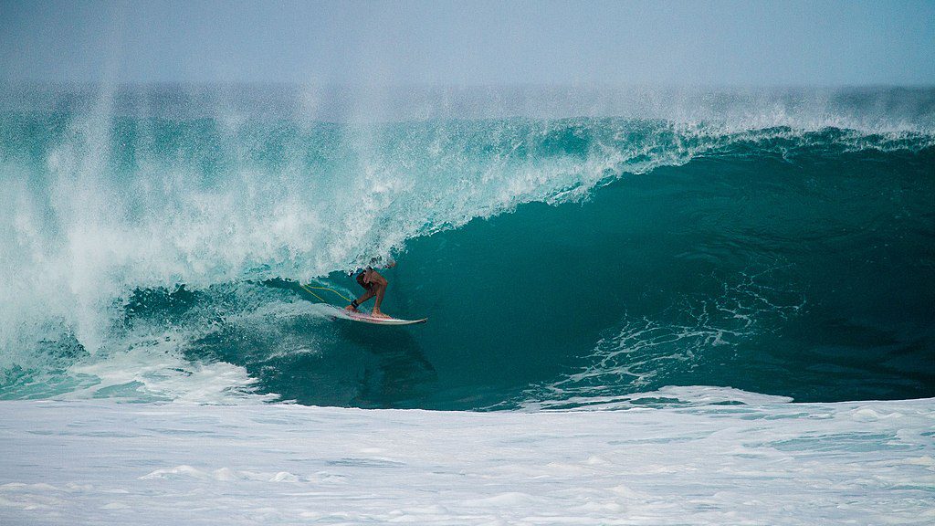 Surfer riding a large wave at the Jersey Shore, showcasing the region's ideal surfing conditions and vibrant surf culture.