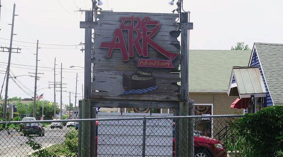 The Ark Pub and Eatery sign featuring rustic wooden design, known for clam chowder and raw bar, located in Point Pleasant Beach.