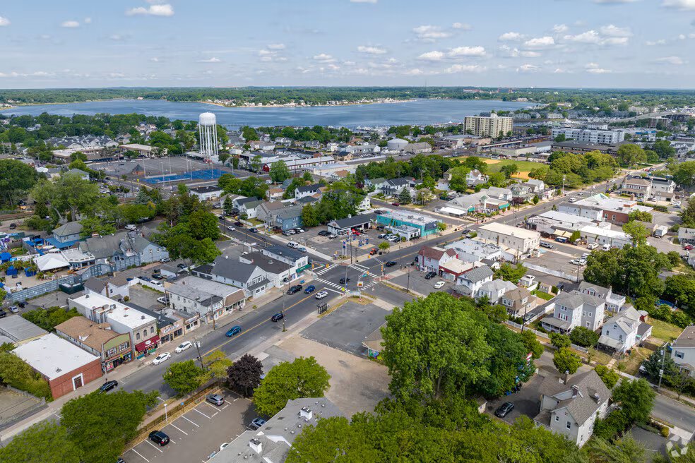 Aerial view of Lake Como, NJ, showcasing residential neighborhoods, local businesses, and proximity to the water, highlighting the peaceful atmosphere ideal for romantic getaways and group vacations.