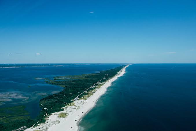 Aerial view of Island Beach State Park, a long, narrow barrier island with sandy beaches