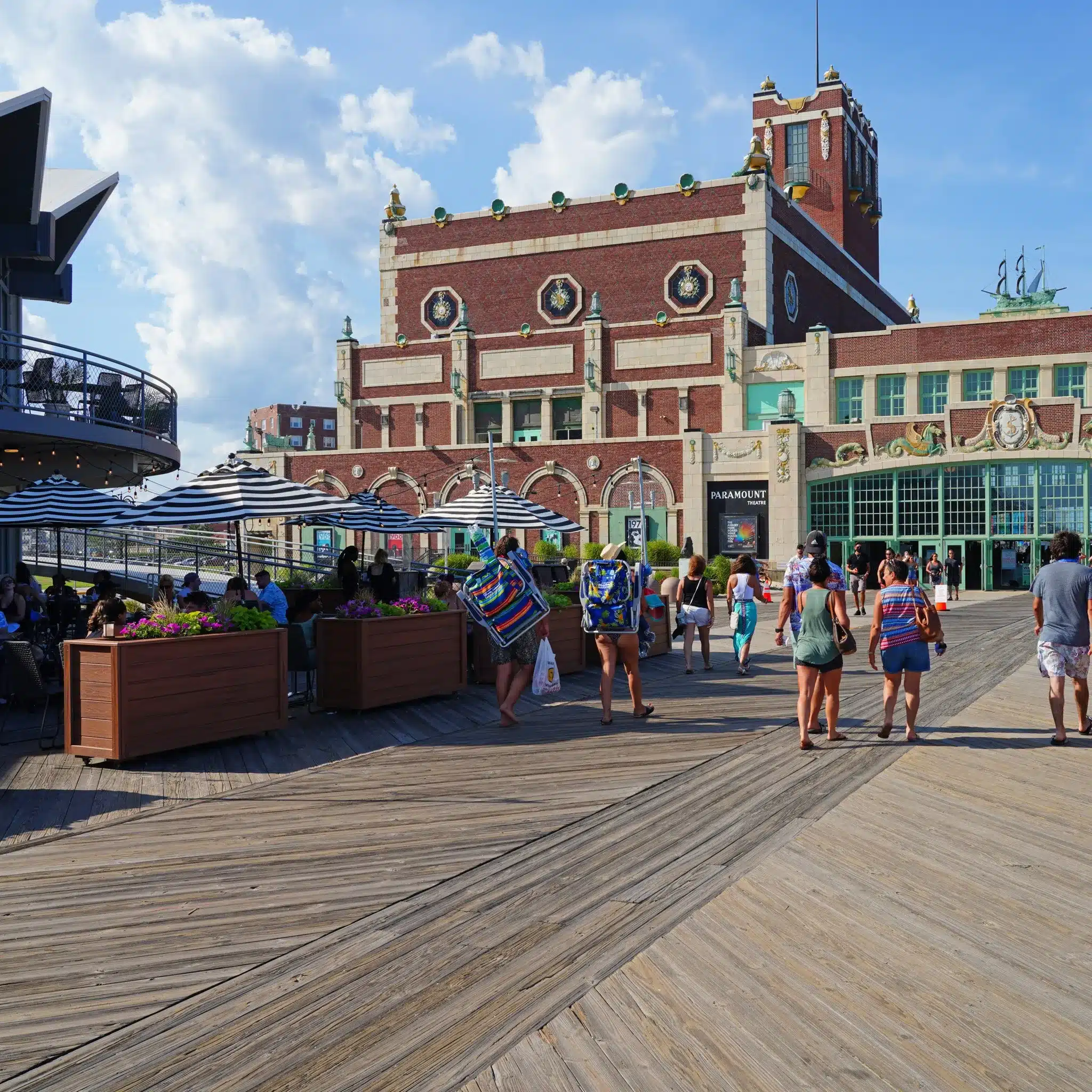 Paramount Theatre and boardwalk scene with people enjoying a Jersey Shore day.