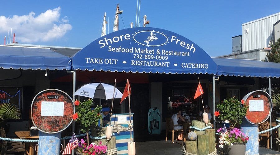 Shore Fresh Seafood Market and Restaurant entrance with blue awning.