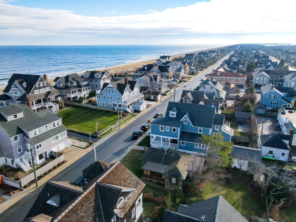 Aerial view of Bay Head, New Jersey, showcasing charming Victorian homes along a coastal street with pristine beaches in the background.