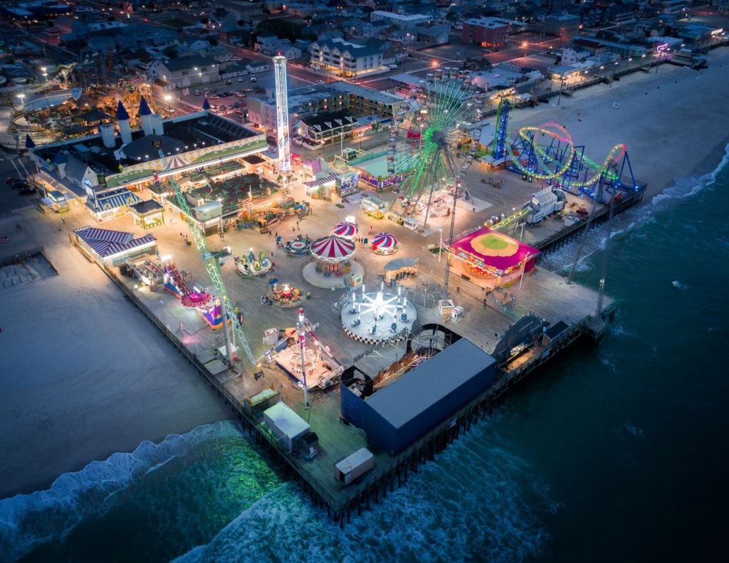 Aerial view of the Jersey Shore featuring beachgoers, sandy coastline, and vibrant beach towns.