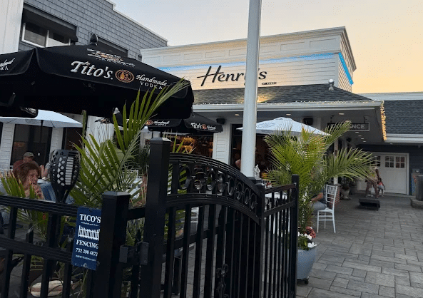 Henry’s restaurant exterior with Tito’s Vodka branding and outdoor seating in Seaside Heights.