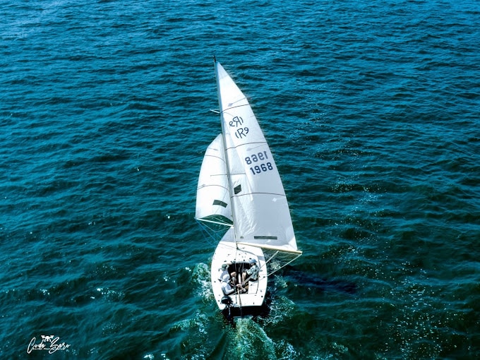 Sailboat navigating the vibrant waters of Barnegat Bay, showcasing the sailing activities at Toms River Yacht Club during spring.