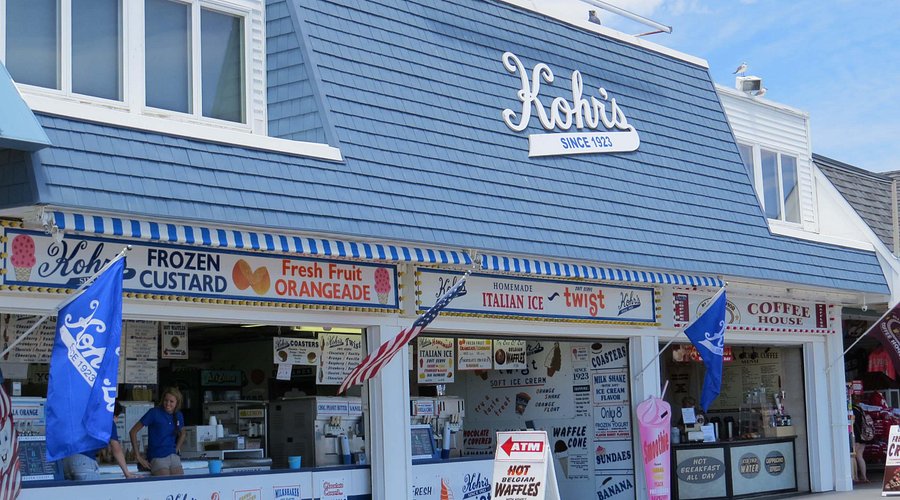 Kohr's Frozen Custard stand at the Jersey Shore, featuring colorful signage for frozen custard, Italian ice, and fresh fruit drinks, with a staff member serving customers.