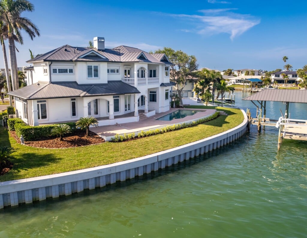 Luxurious waterfront home in a serene coastal community, showcasing upscale architecture and lush landscaping, ideal for year-round living at the Jersey Shore.