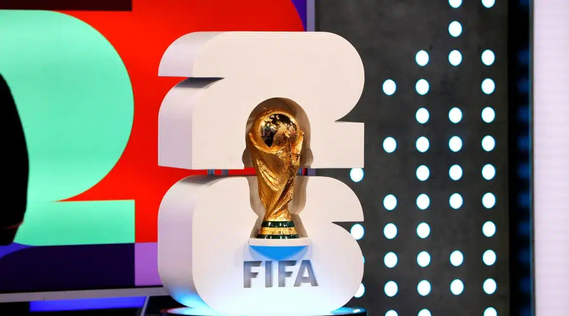 FIFA World Cup 2026 trophy display with colorful backdrop, symbolizing excitement for upcoming matches and events.