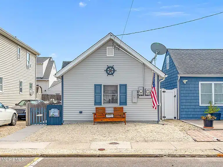Duplex property at 263 Kearney Avenue, Seaside Heights, NJ, featuring blue shutters, an American flag, and a welcoming front porch, ideal for short-term rental investment.