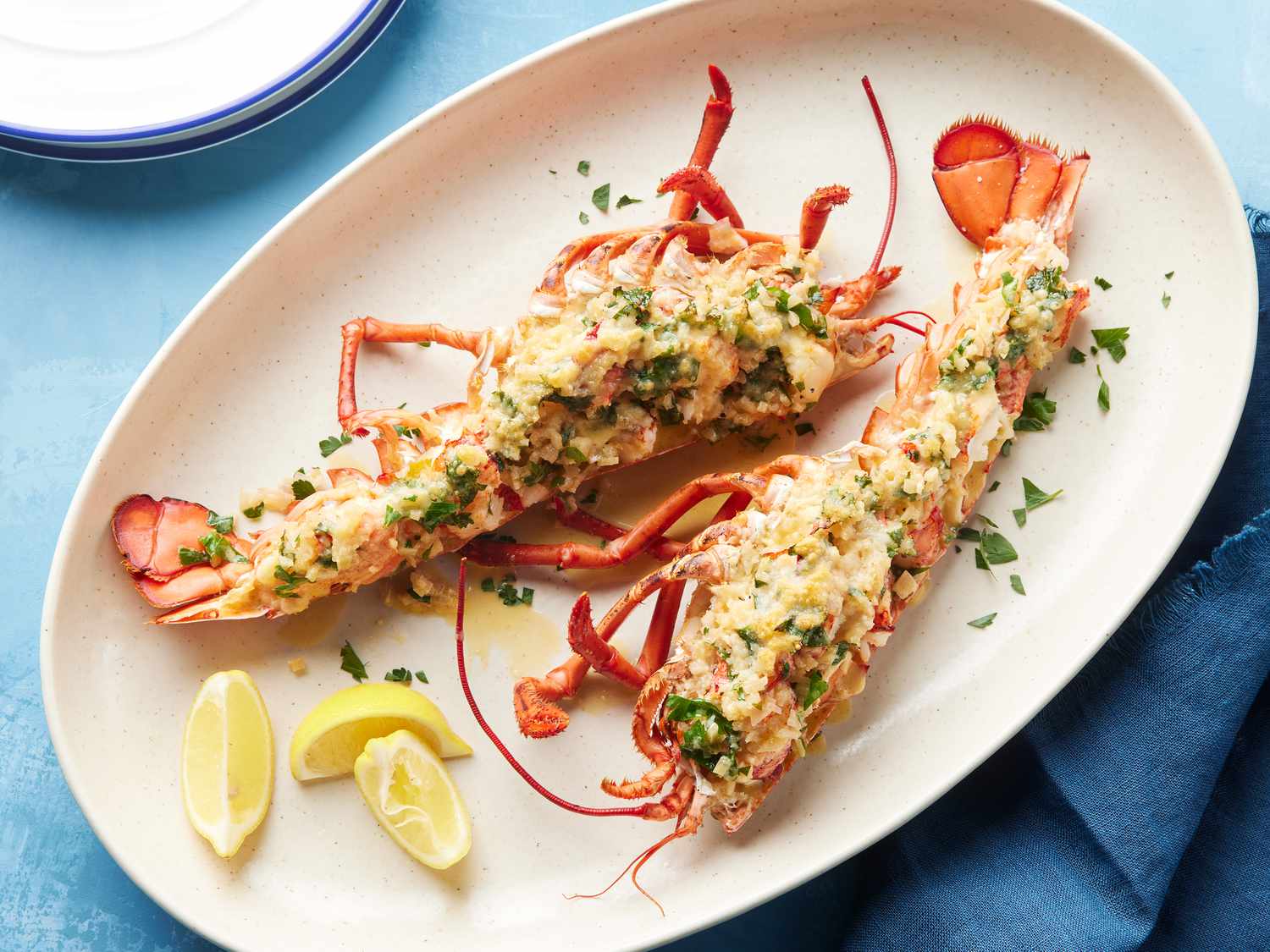 Lobster Thermidor served on a plate with lemon wedges, garnished with parsley, highlighting a delicious seafood dish perfect for upscale dining experiences at the Jersey Shore.