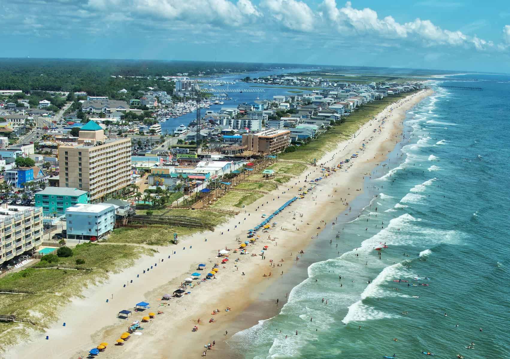 Aerial view of the beach with buildings in the background
