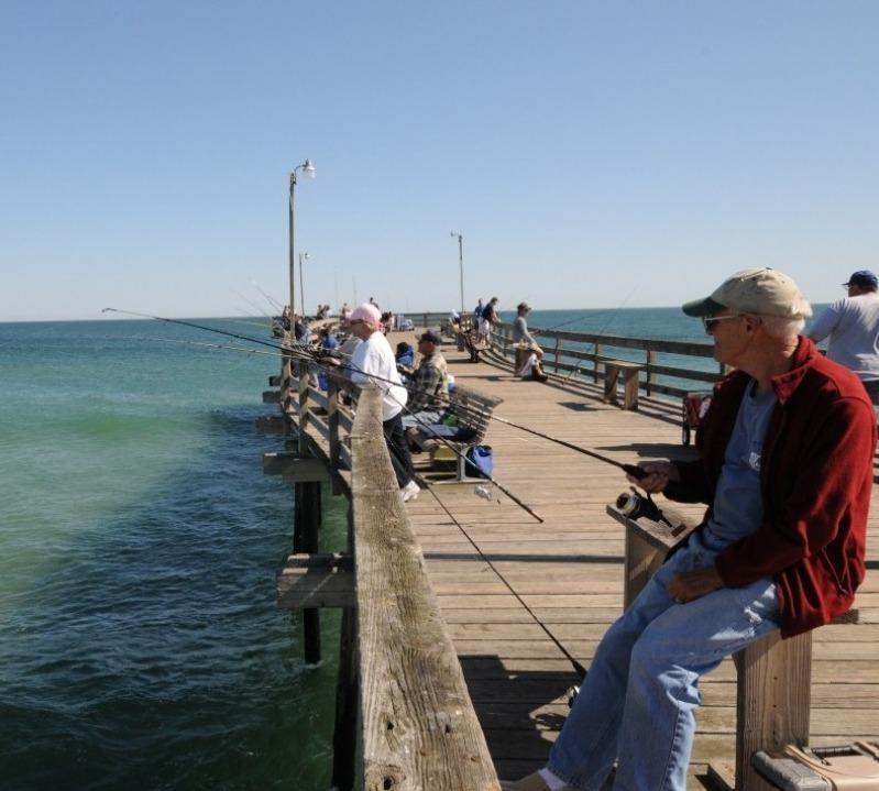 anglers enjoying fishing from the deck of a pier