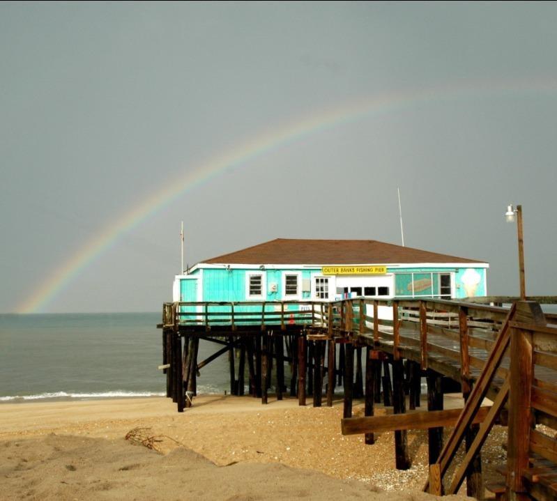 a rainbow over a pier