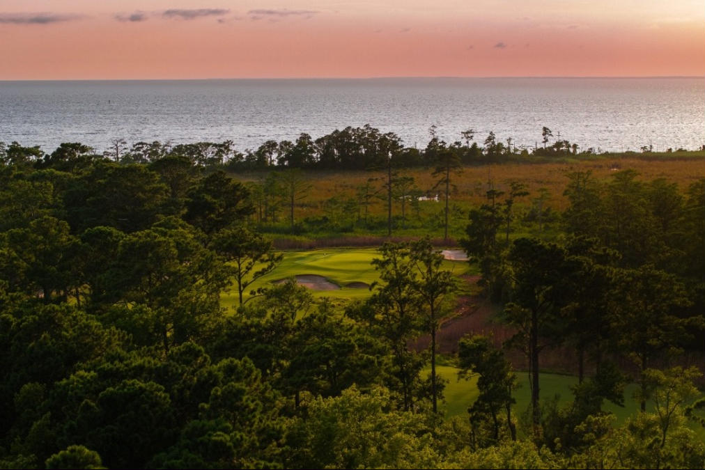 overhead look at a golf course with the sunset