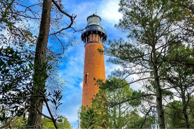 a brick lighthouse with trees