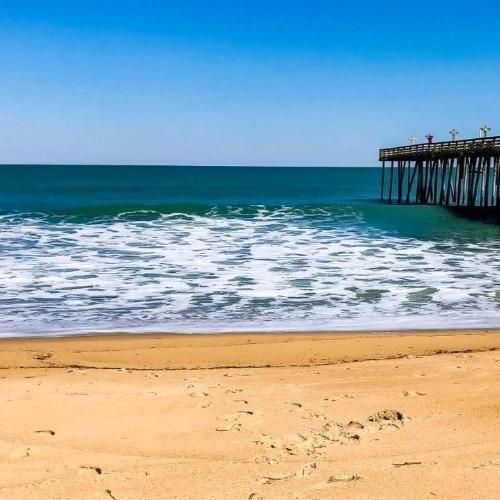 one the beach looking at a pier