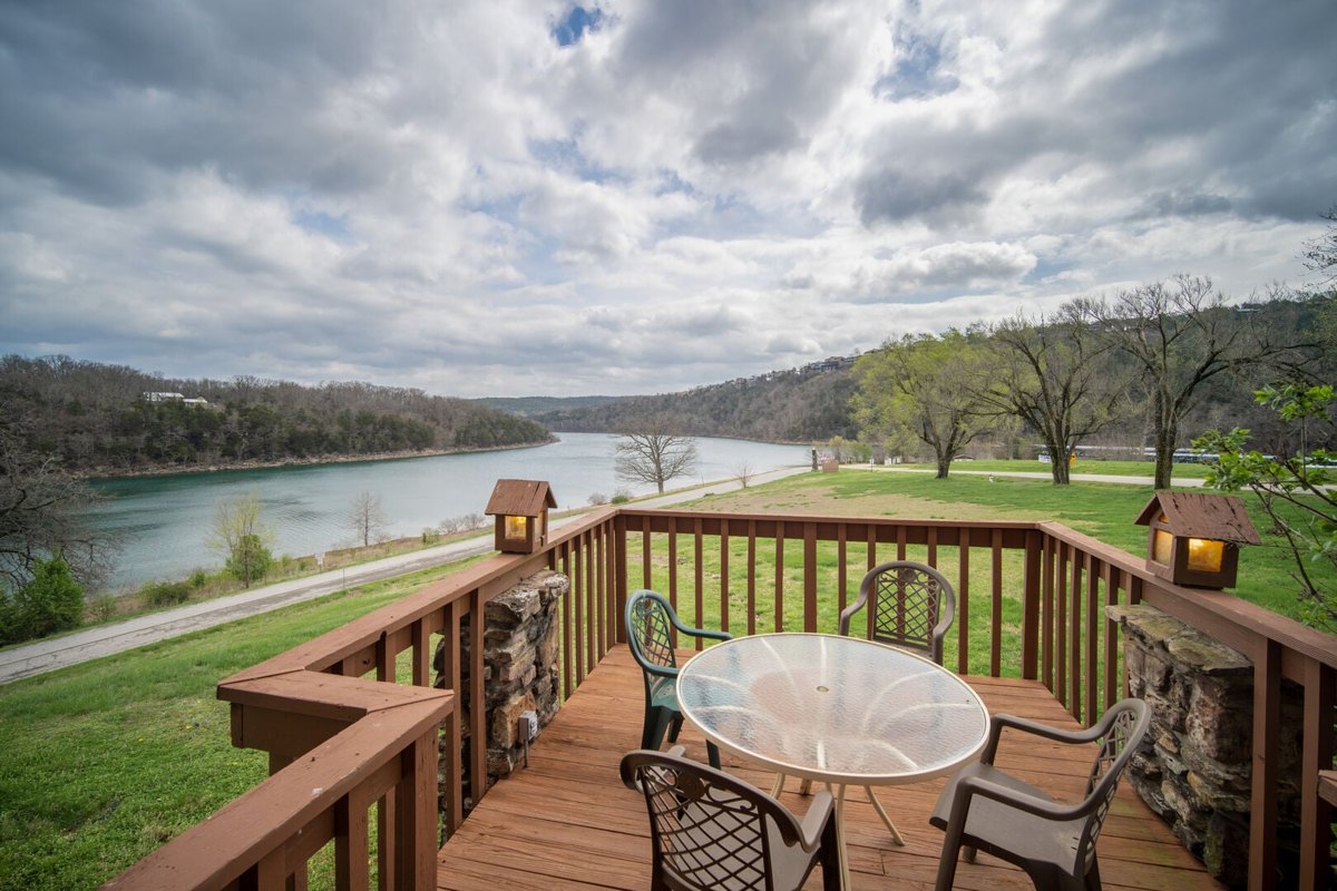 Wooden deck with patio seating overlooking Table Rock Lake at a Branson lakefront vacation rental