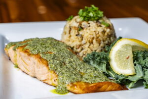 bransons restaurant fish steak, green vegetable and rice with green toppings