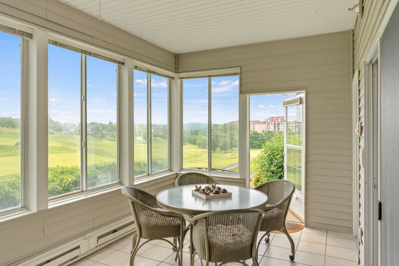 Enclosed sunroom at a Legacy at Thousand Hills golf condo overlooking the fairways of Thousand Hills Golf Course in Branson, Missouri