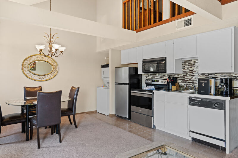 Kitchen and dining area beneath the loft bedroom in a two-level Fall Creek condo rental in Branson