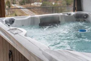 Private outdoor hot tub on a Branson cabin deck surrounded by Ozark trees data-srcset=