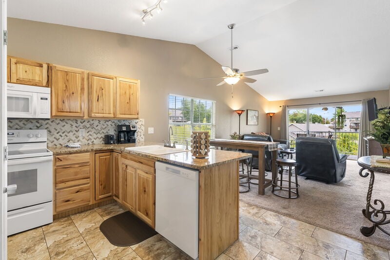Open kitchen with light wood cabinets and a breakfast bar in a two-bedroom Fall Creek condo rental in Branson, Missouri
