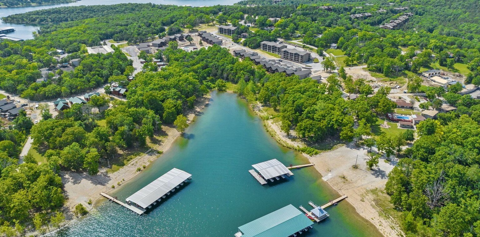 Aerial view of covered boat docks in a wooded Table Rock Lake cove at Table Rock Resorts on Indian Point in Branson, Missouri