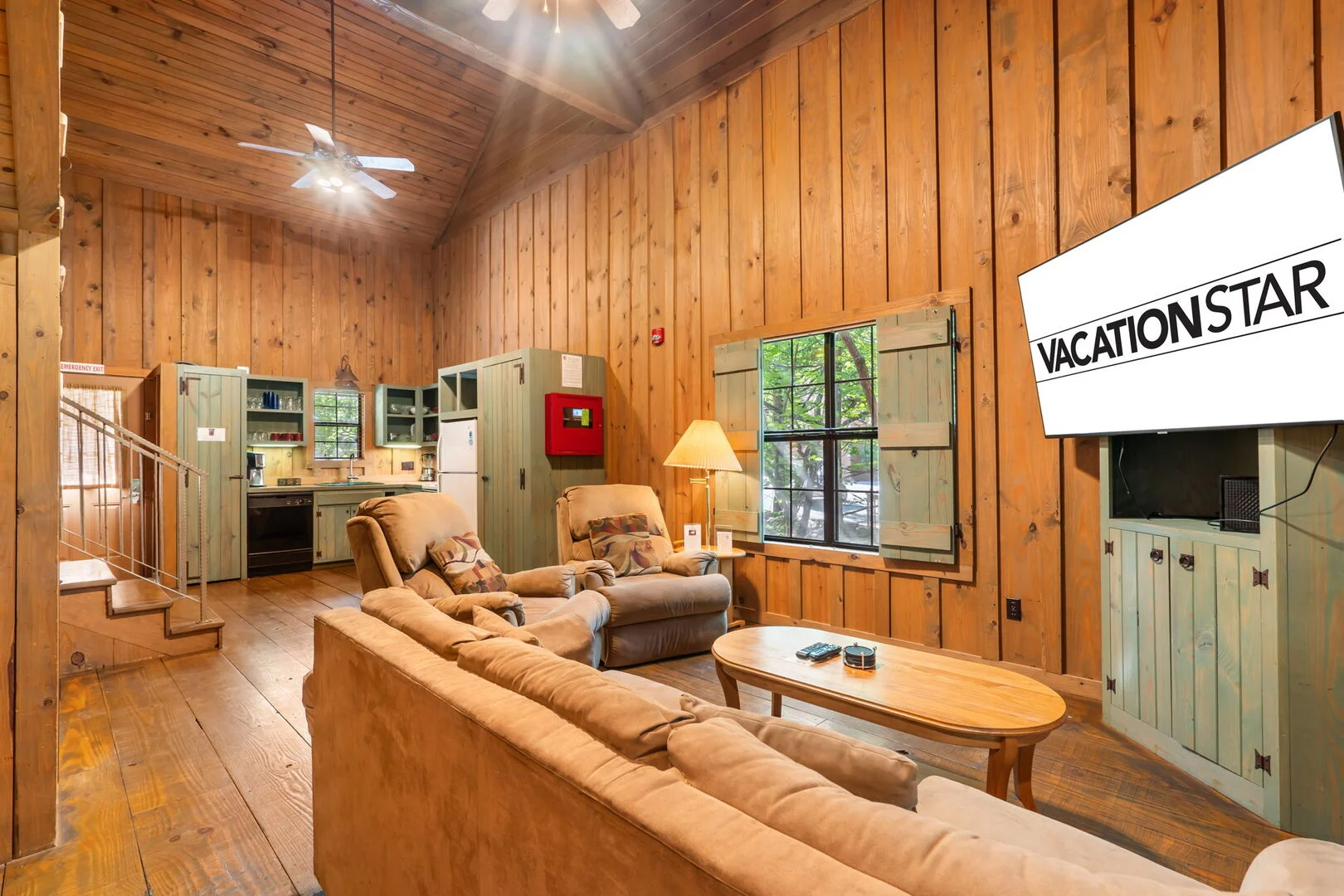 Living room with TV in a two-bedroom floor plan at Cabins at Green Mountain, a Thousand Hills Vacations property in Branson, Missouri