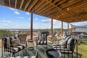 Private deck with a hot tub and fire pit at a Branson vacation rental data-srcset=